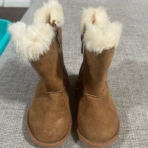 Magellan Outdoors brown fuzzy boots with zipper on inside.